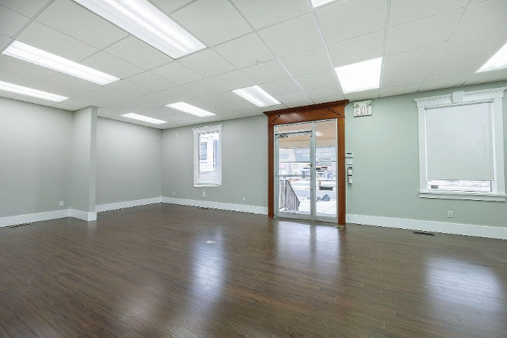 Front entrance with original wood trim and storefront glass