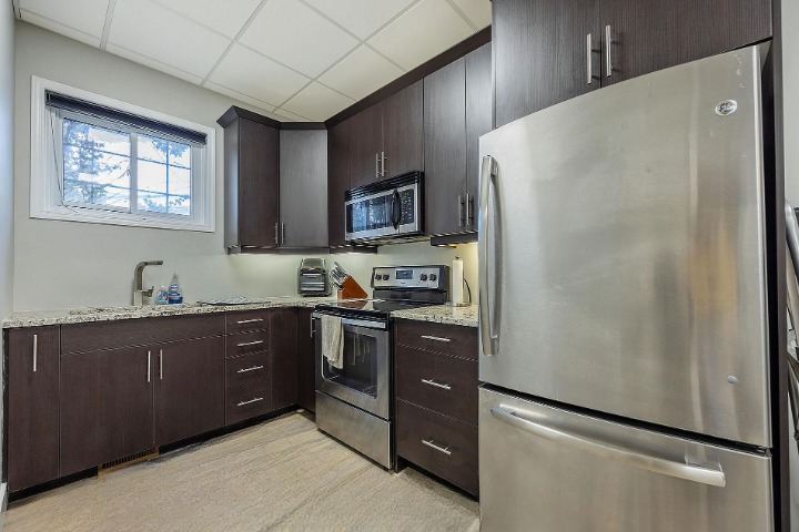 Kitchen with stainless appliances and dark cabinetry